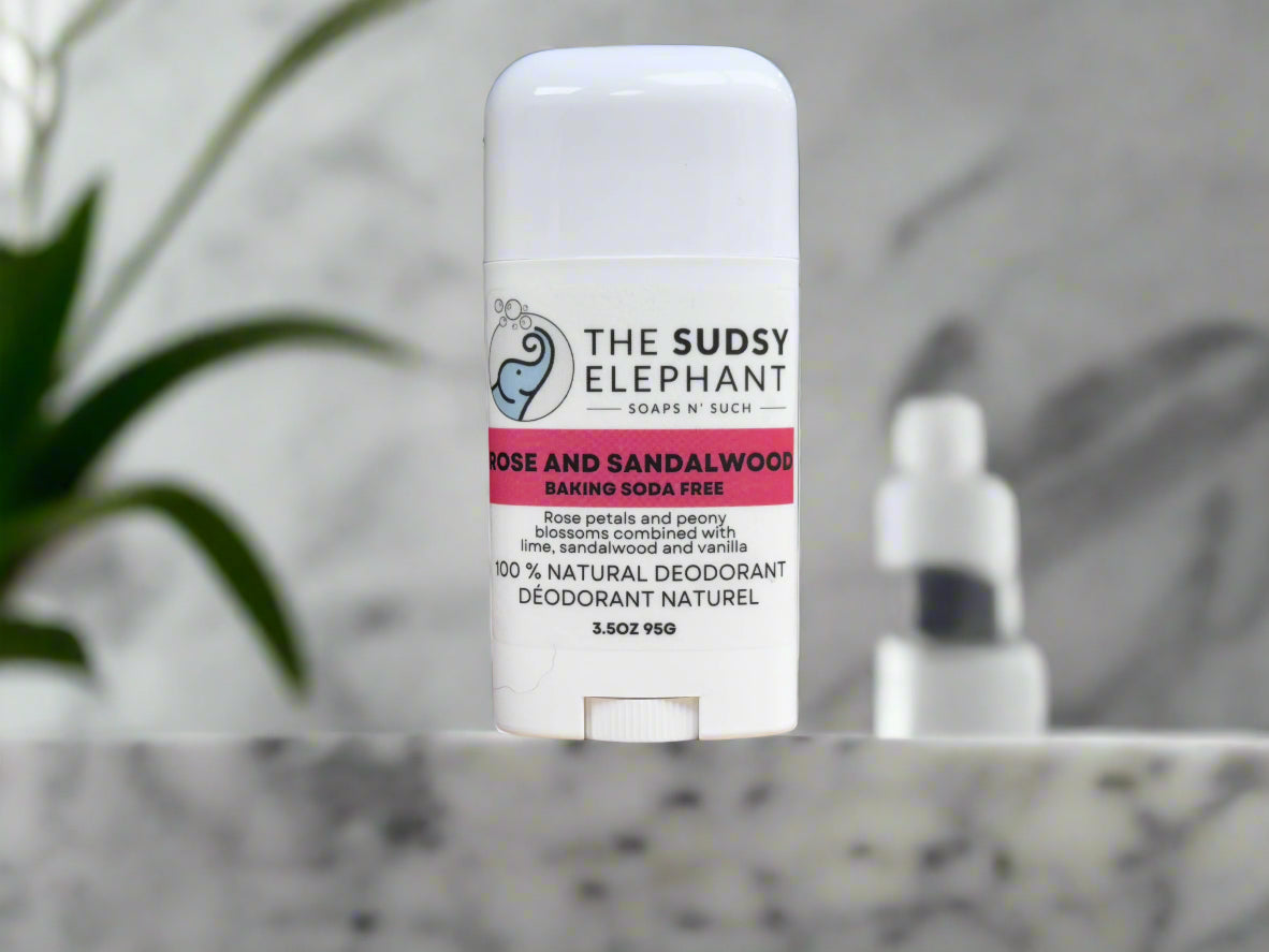 Deodorant stick from 'The Sudsy Elephant' on a wooden surface with a blurred background