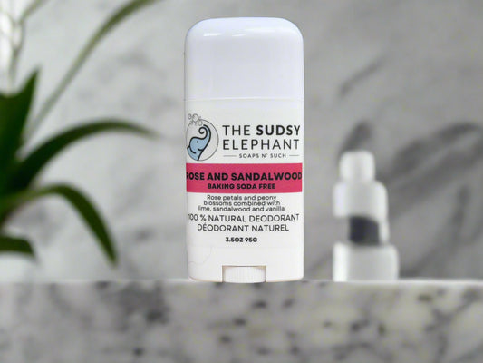 Deodorant stick from 'The Sudsy Elephant' on a wooden surface with a blurred background